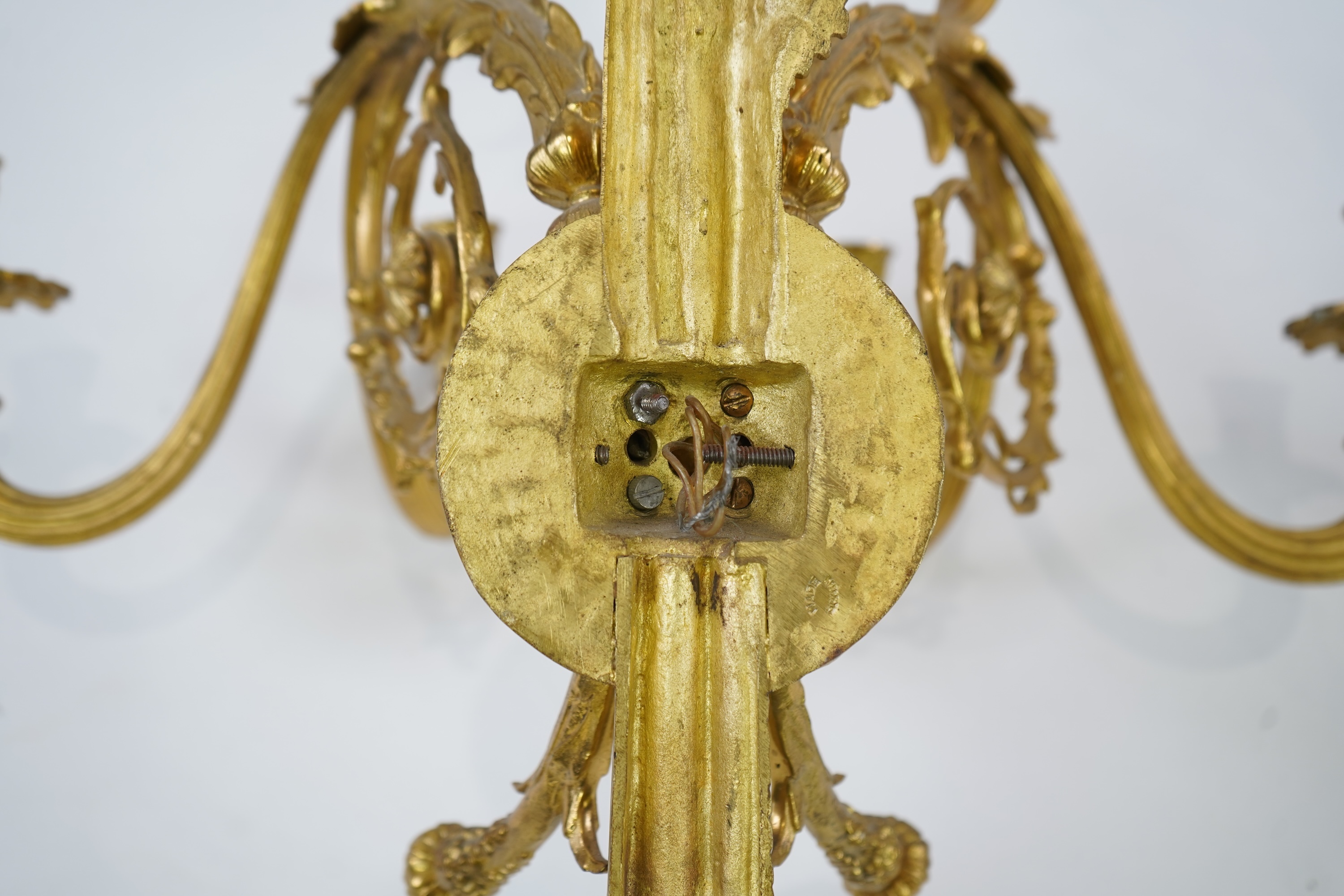 A pair of large Louis XVI style ormolu four branch wall sconces
